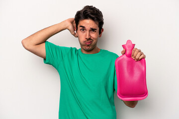 Young caucasian man holding a water bag isolated on white background being shocked, she has...