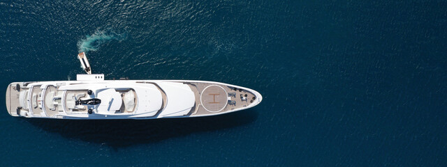 Aerial drone ultra wide panoramic photo of luxury yacht with wooden deck anchored in Mediterranean...