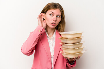 Young business English woman holding tupperware of food isolated on white background trying to listening a gossip.