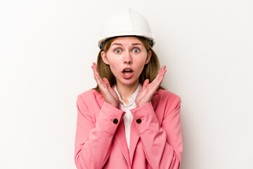 Young architect English woman with helmet isolated on white background surprised and shocked.