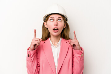Young architect English woman with helmet isolated on white background pointing upside with opened mouth.