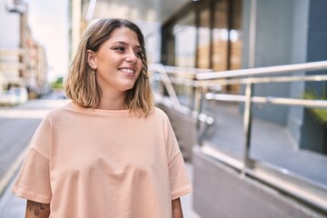 Young hispanic woman smiling confident at street