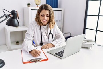 Young hispanic woman wearing doctor stethoscope working at clinic