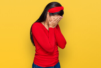 Young hispanic woman wearing casual clothes with sad expression covering face with hands while crying. depression concept.