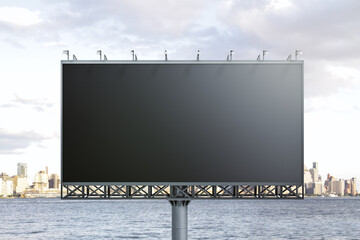 Blank black horizontal billboard on skyline background, front view. Mock up, advertising concept