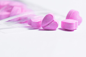 Ziplock bag and pink heart shaped pills.