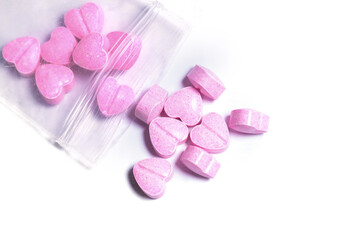 Ziplock bag and pink heart shaped pills.