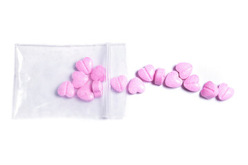 Ziplock bag and pink heart shaped pills.