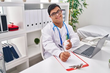 Down syndrome man wearing doctor uniform prescribe pills at clinic