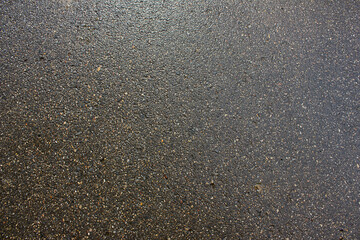 The background of the wet asphalt close-up. Asphalt texture