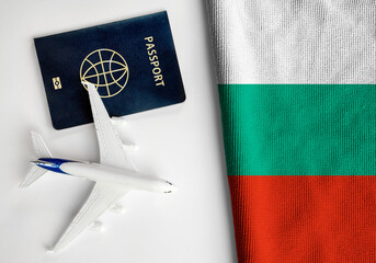 Flag of Bulgaria with passport and toy airplane. Flight travel concept.
