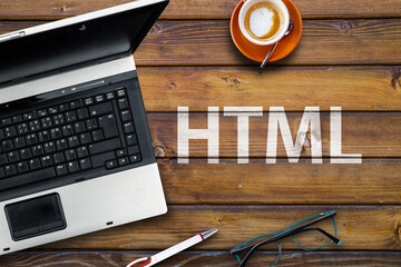 HTML Hyper Text Markup Language.. Word html and laptop, glasses and coffee on wooden table 