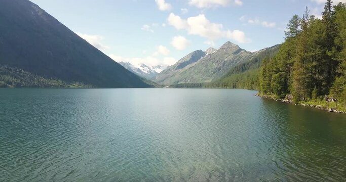 Panoramic aerial morning view of famous natural attraction of Altai and Russia - the Multa mountain lake at sunrise. National park and outdoor recreation background