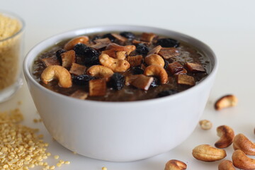 Sweet Pongal. An Indian sweet dish made of white rice and yellow moong lentils and jaggery. Garnished with ghee fried cashews nuts and coconut bits