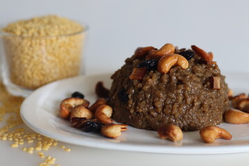 Sweet Pongal. An Indian sweet dish made of white rice and yellow moong lentils and jaggery. Garnished with ghee fried cashews nuts and coconut bits