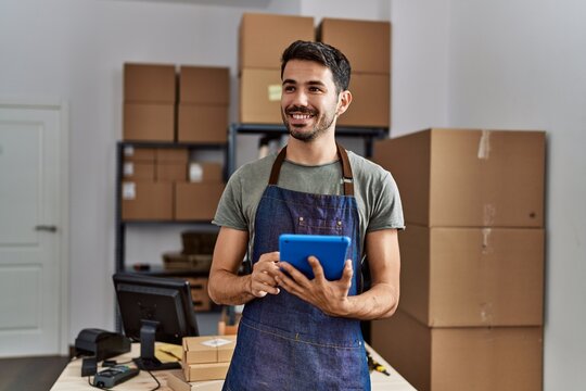 Young hispanic man business worker using touchpad at storehouse