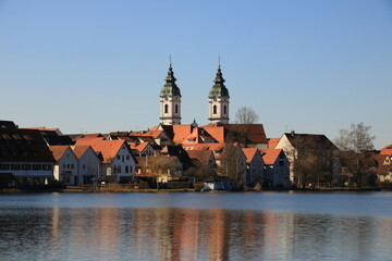 Fototapeta na wymiar Blick auf den Ort Bad Waldsee. Die Türme der Stiftskirche spiegeln sich im Stadtsee