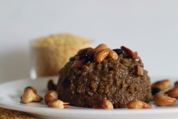 Sweet Pongal. An Indian sweet dish made of white rice and yellow moong lentils and jaggery. Garnished with ghee fried cashews nuts and coconut bits