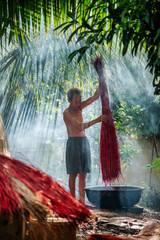 Vietnamese Old Man drying traditional vietnam mats in the old traditional village at dinh yen, dong thap, vietnam, tradition artist concept,Vietnam.