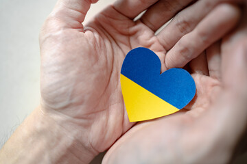 Fototapeta Ukraine flag color heart in hands obraz