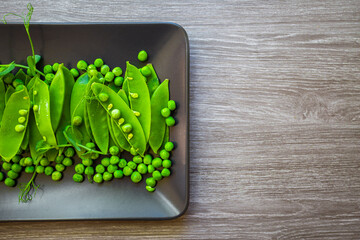 Top view of healthy organic food: green vegetables, seeds and herbs on light background. Source of protein for vegetarians.