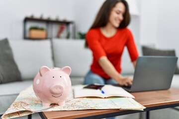 Young hispanic woman organizing trip at home