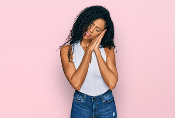 Middle age african american woman wearing casual style with sleeveless shirt sleeping tired...