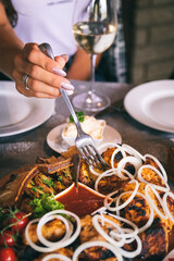 The food is cooked on the grill. Plate with barbecue, sauce and salad.