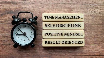 Wooden blocks with text - Time management, self discipline, positive mindset, result oriented....