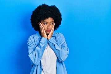 Fototapeta na wymiar Young african american woman wearing casual clothes tired hands covering face, depression and sadness, upset and irritated for problem