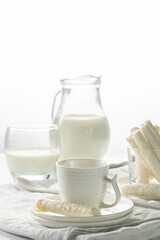 Jug with milk and coconut flake sweet waffle rolls