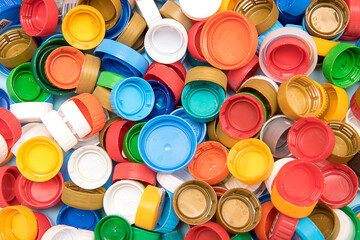Background of multi-colored used plastic caps for text