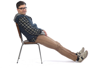 man sitting relaxed sitting on a chair looking at camera on white background