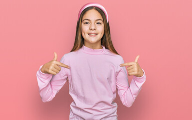 Beautiful brunette little girl wearing casual turtleneck sweater looking confident with smile on face, pointing oneself with fingers proud and happy.