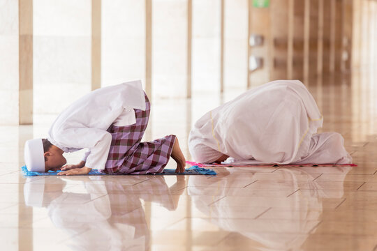 Young couple doing Salat with prostrate gesture