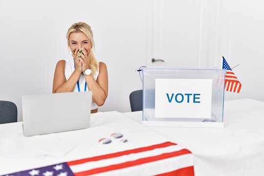 Young Caucasian Woman At America Political Campaign Election Laughing And Embarrassed Giggle Covering Mouth With Hands, Gossip And Scandal Concept