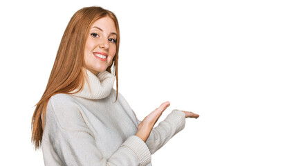 Young irish woman wearing casual winter sweater inviting to enter smiling natural with open hand