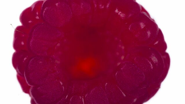 Сrushing Raspberry in 5 Stories. Raspberrys are compressed and crushed close-up on a bright white background, creating a juicy burst of pulp and a bright shell. Shooting at 120fps