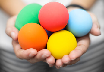 Closed up of  woman’s hands holding colorful Easter eggs. Easter festival concept