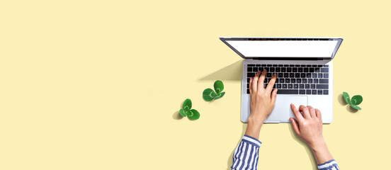 Laptop computer with shamrock leaves - flat lay