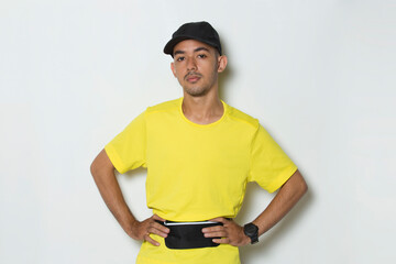 portrait young sporty man dressed in yellow tshirt on white background

