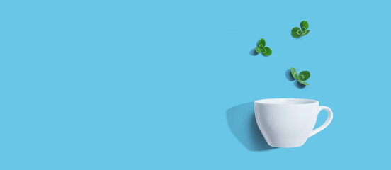 Shamrock leaves with coffee cup - flat lay
