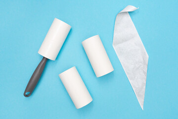 Sticky Hair Removal Roller. Lint Roller Dog, Cat, Animal, Hair Remover. Pet Fur, Fuzz. Blue background. Flat lay. Top view