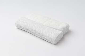 two rolls of white bandage isolated on white background