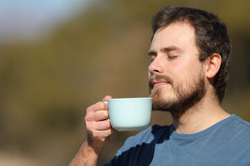 Man enjoying coffee cup in nature
