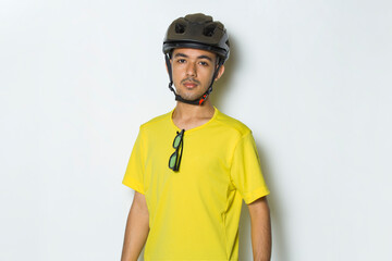 portrait young handsome man wearing cyclist helmet isolated on white background
