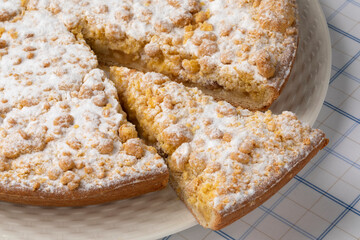 Traditional Dutch  Apple crumble cake and a piece close up