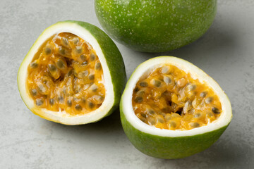 Fresh juicy whole and halved passion fruit close up  