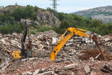 Russia, Gadzhievo - August 14, 2021: demolition of residential buildings with construction equipment