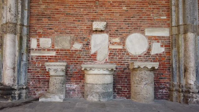 archaeological finds from the Greek-Roman age with columns, capitals in Ionic, Doric and classical style in Sant'Ambrogio Church in Milan Italy Heritage 